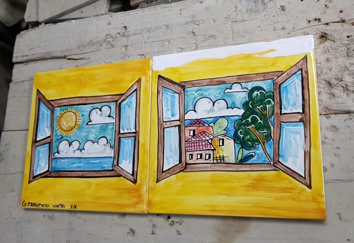 Hand-painted ceramics depicting windows onto the sea and gardens